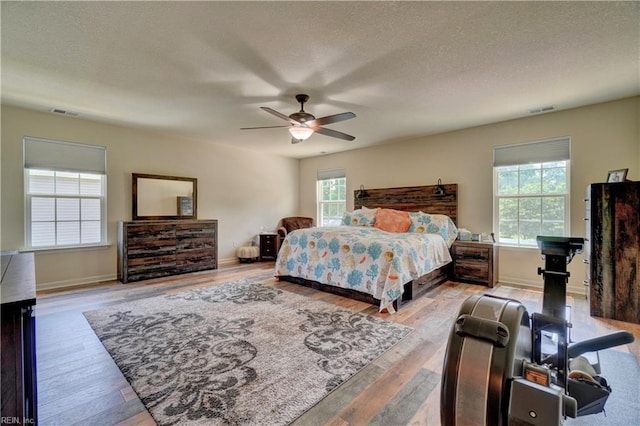 6884 Emerson Ln, Hayes, VA 23072 - bedroom featuring wood finished floors, baseboards, a ceiling fan, and a textured ceiling