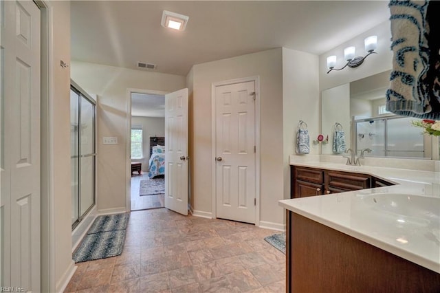 6884 Emerson Ln, Hayes, VA 23072 - ensuite bathroom featuring a shower stall, vanity, baseboards, and stone finish flooring