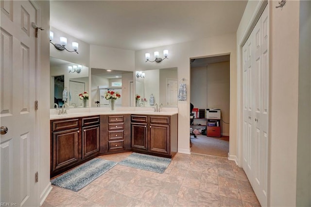 6884 Emerson Ln, Hayes, VA 23072 - full bath featuring double vanity, baseboards, and stone finish floors