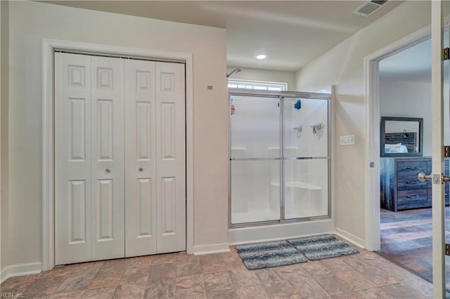 6884 Emerson Ln, Hayes, VA 23072 - full bathroom with a closet, a stall shower, baseboards, and stone finish floors