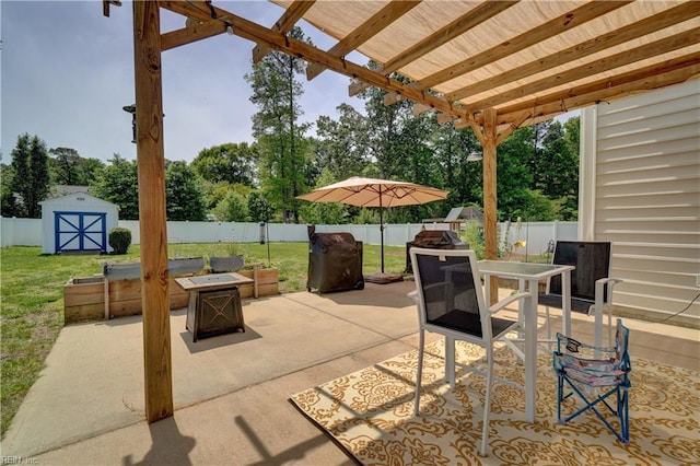 6884 Emerson Ln, Hayes, VA 23072 - view of patio featuring a fire pit, a storage unit, outdoor dining area, view of scattered trees, and a pergola
