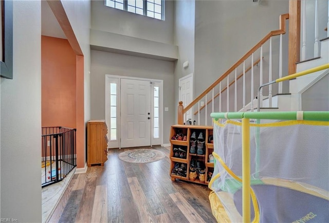 6884 Emerson Ln, Hayes, VA 23072 - entryway featuring hardwood / wood-style floors, stairs, a high ceiling, and baseboards