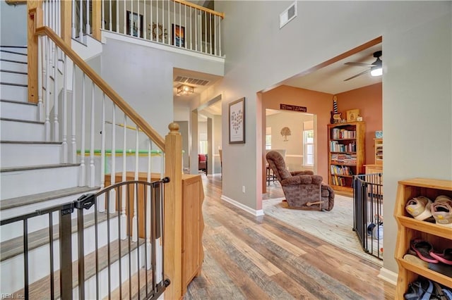 6884 Emerson Ln, Hayes, VA 23072 - foyer entrance with wood finished floors, ceiling fan, a high ceiling, baseboards, and stairs