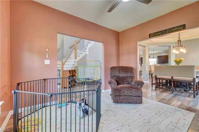 6884 Emerson Ln, Hayes, VA 23072 - sitting room with wood finished floors, a ceiling fan, a chandelier, and baseboards