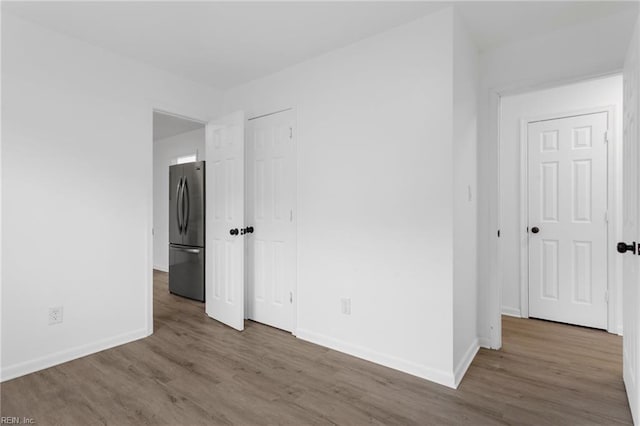1304 Woodcrest Dr, Hampton, VA 23663 - unfurnished bedroom with freestanding refrigerator, baseboards, and wood finished floors