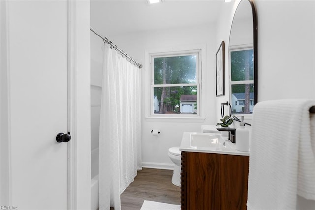 1304 Woodcrest Dr, Hampton, VA 23663 - bathroom with vanity, toilet, wood finished floors, and baseboards