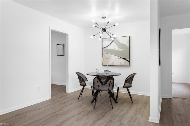 1304 Woodcrest Dr, Hampton, VA 23663 - dining room featuring a chandelier, wood finished floors, and baseboards