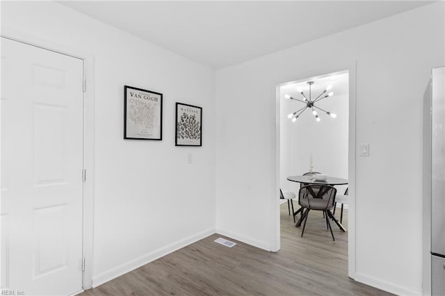 1304 Woodcrest Dr, Hampton, VA 23663 - corridor with wood finished floors, a chandelier, and baseboards