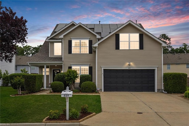 825 Wyemouth Dr, Newport News, VA 23602 - traditional-style house with a front lawn, roof mounted solar panels, concrete driveway, and an attached garage