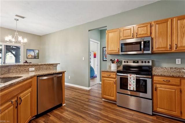 825 Wyemouth Dr, Newport News, VA 23602 - kitchen featuring stainless steel appliances, a chandelier, dark wood-type flooring, light stone counters, and hanging light fixtures