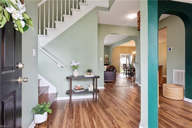 825 Wyemouth Dr, Newport News, VA 23602 - foyer with arched walkways, wood finished floors, stairs, and baseboards
