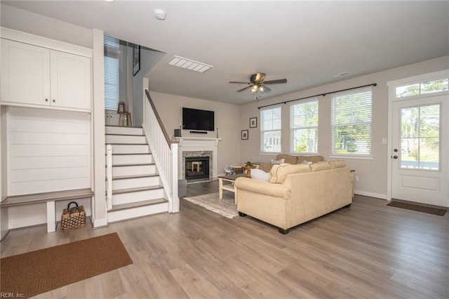 1951 Flintshire Dr, Chesapeake, VA 23323 - living area featuring a premium fireplace, light wood-style floors, a ceiling fan, stairs, and baseboards