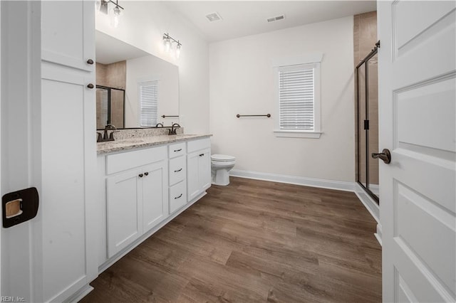 5376 Kenmere Ln, Smithfield, VA 23430 - full bath with a stall shower, double vanity, baseboards, wood finished floors, and toilet