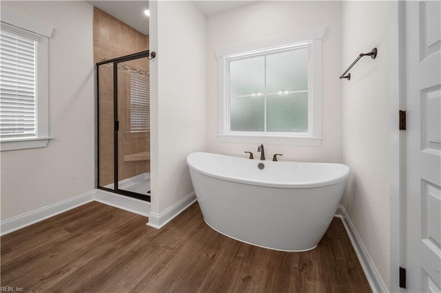5376 Kenmere Ln, Smithfield, VA 23430 - bathroom featuring a stall shower, wood finished floors, a freestanding tub, baseboards, and plenty of natural light