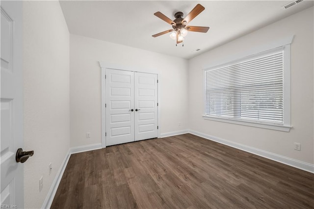 5376 Kenmere Ln, Smithfield, VA 23430 - unfurnished bedroom featuring dark wood-style floors, baseboards, a closet, and ceiling fan