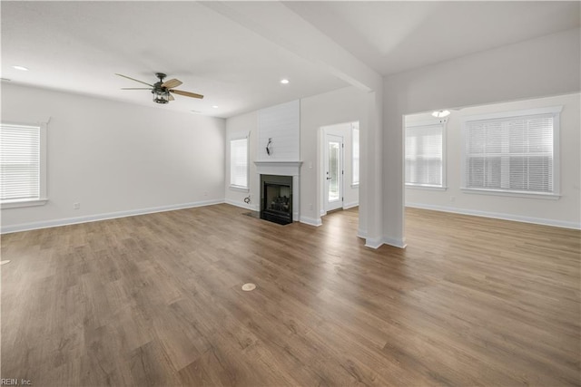 5376 Kenmere Ln, Smithfield, VA 23430 - unfurnished living room featuring a ceiling fan, light wood-style flooring, baseboards, a fireplace with flush hearth, and recessed lighting