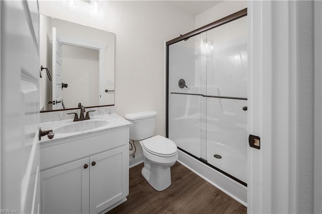 5376 Kenmere Ln, Smithfield, VA 23430 - bathroom with toilet, a stall shower, wood finished floors, and vanity