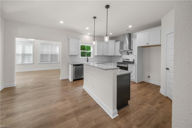 5376 Kenmere Ln, Smithfield, VA 23430 - kitchen with wall chimney range hood, appliances with stainless steel finishes, white cabinets, a center island, and tasteful backsplash