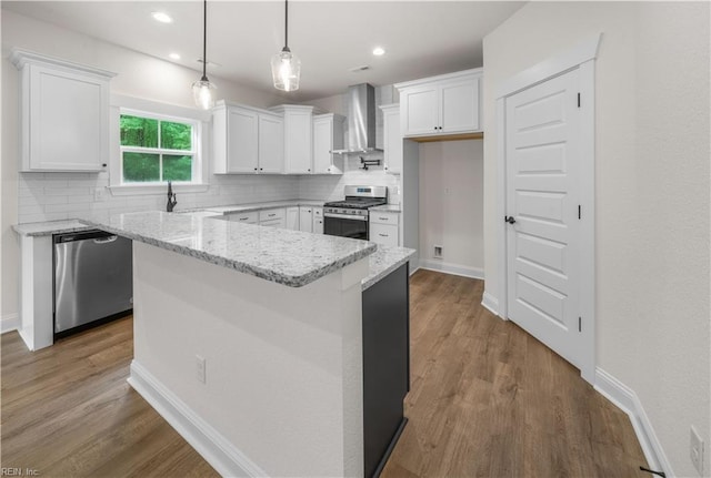 5376 Kenmere Ln, Smithfield, VA 23430 - kitchen featuring wall chimney exhaust hood, appliances with stainless steel finishes, decorative backsplash, white cabinetry, and a kitchen island