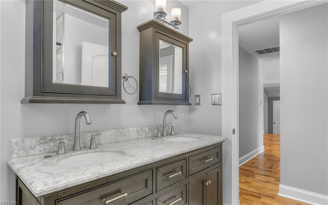 147 Ransone St, Hampton, VA 23669 - bathroom with wood finished floors, double vanity, and baseboards