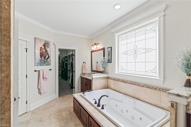 full bath featuring crown molding, a jetted tub, vanity, and a spacious closet