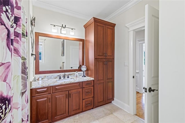 bathroom with crown molding, vanity, and baseboards
