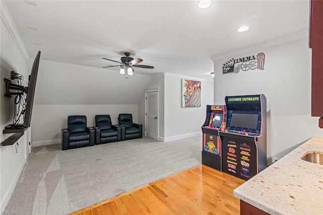 rec room featuring a ceiling fan, crown molding, baseboards, recessed lighting, and vaulted ceiling