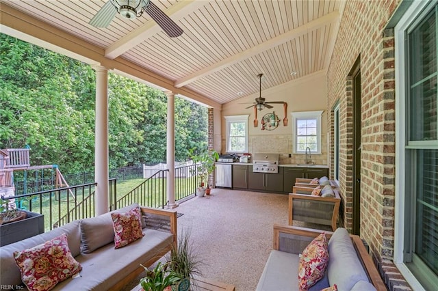 view of patio / terrace with ceiling fan, outdoor lounge area, a sink, exterior kitchen, and a grill