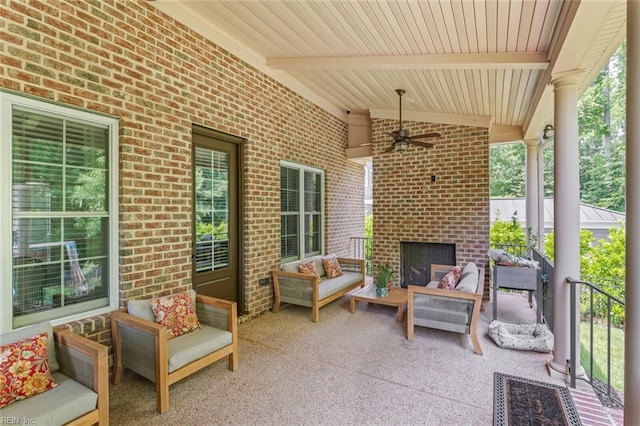 view of patio featuring an outdoor living space with a fireplace and ceiling fan