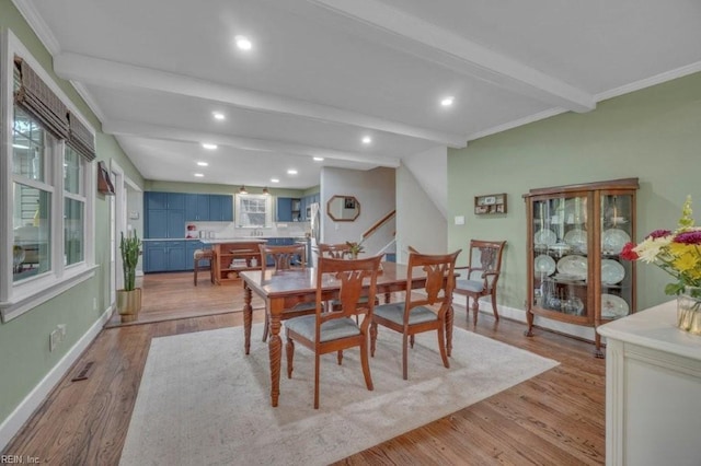 dining room featuring beam ceiling, light wood-type flooring, baseboards, recessed lighting, and crown molding