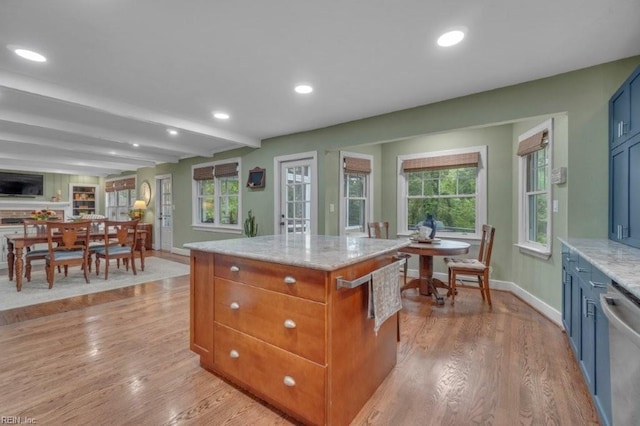 kitchen with dishwasher, baseboards, light wood-style flooring, light stone countertops, and beamed ceiling