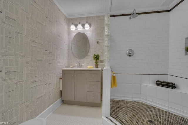 full bath featuring ornamental molding, tiled shower, tile patterned flooring, and vanity