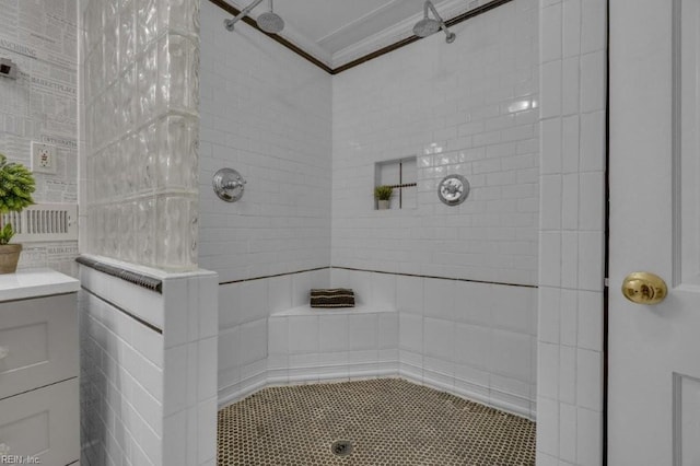 bathroom featuring crown molding and tiled shower