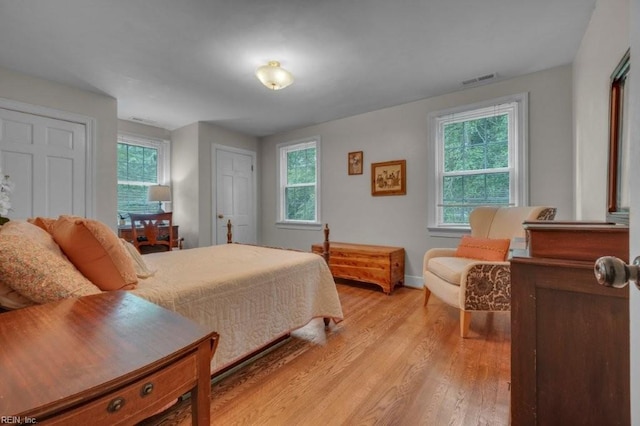 bedroom with light wood-type flooring and baseboards