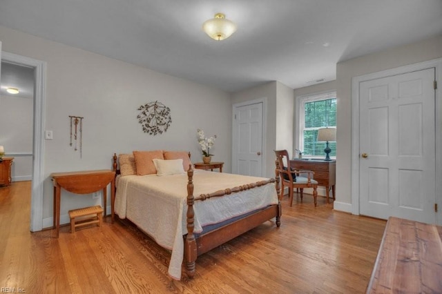 bedroom with light wood-style flooring and baseboards