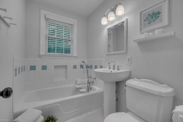 full bath featuring toilet and a bath