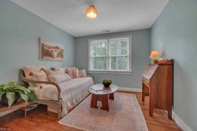 living room featuring baseboards and wood finished floors