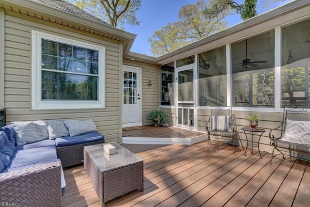 deck with outdoor lounge area and a sunroom