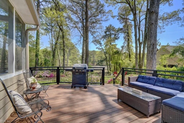 wooden deck with an outdoor living space and area for grilling