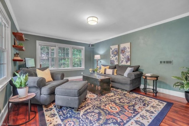 living area featuring crown molding, wood finished floors, and baseboards