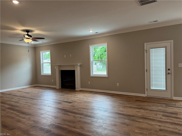 unfurnished living room with ornamental molding, baseboards, a ceiling fan, dark wood-style flooring, and a fireplace
