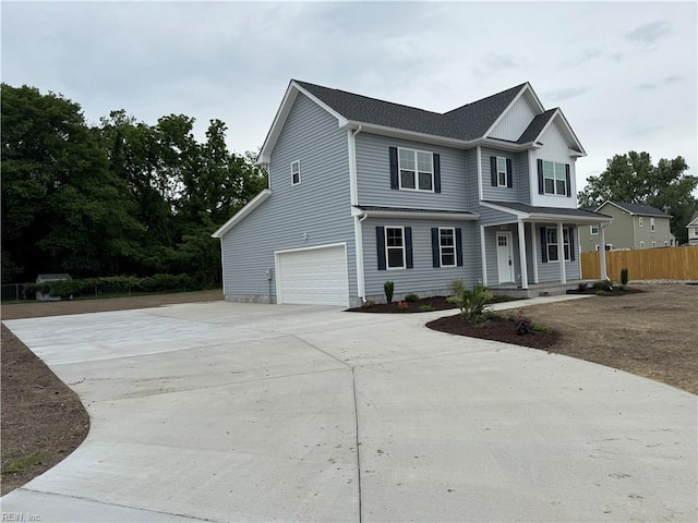 view of front of home featuring concrete driveway, a garage, a porch, and fence