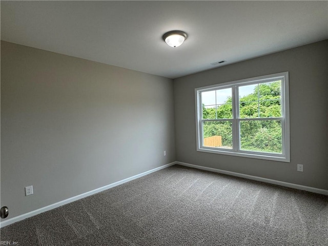 carpeted empty room with baseboards