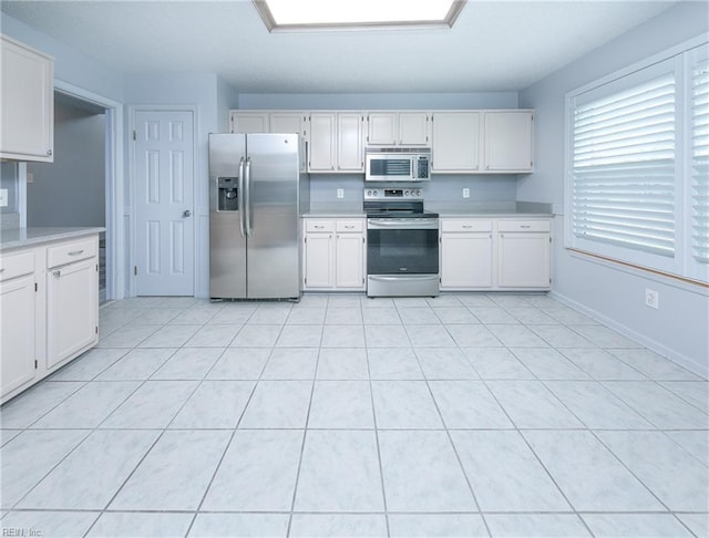 5191 Cypress Point Cir, Virginia Beach, VA 23455 - kitchen featuring stainless steel appliances, light countertops, white cabinetry, and light tile patterned floors