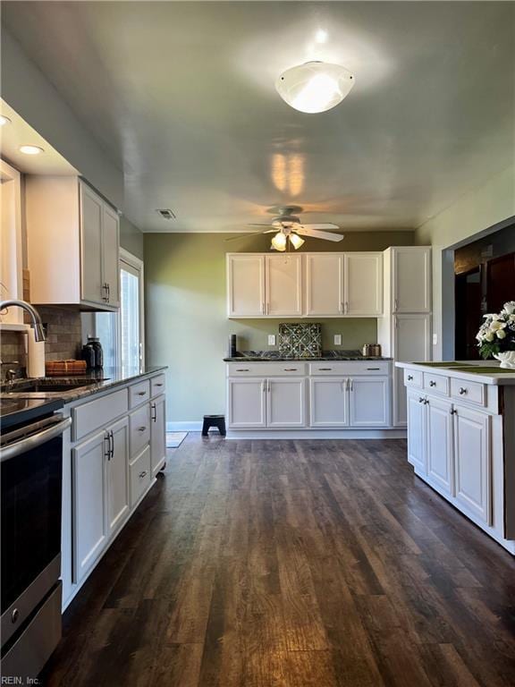 kitchen featuring white cabinets, a sink, stainless steel range with electric stovetop, and ceiling fan