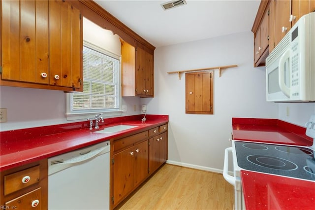 414 Bryan Ct, Newport News, VA 23606 - kitchen with white appliances, a sink, light wood-style flooring, brown cabinetry, and baseboards