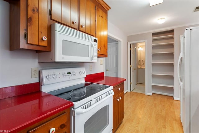 414 Bryan Ct, Newport News, VA 23606 - kitchen featuring white appliances, brown cabinetry, light wood-style floors, and dark countertops