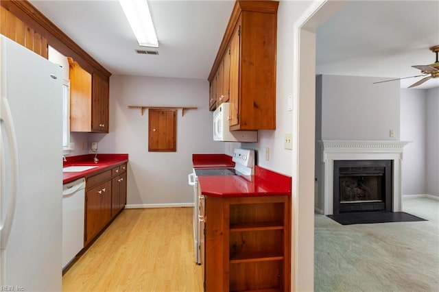 414 Bryan Ct, Newport News, VA 23606 - kitchen with white appliances, brown cabinets, a ceiling fan, a fireplace with flush hearth, and baseboards