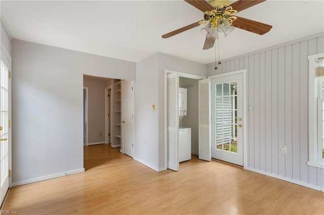414 Bryan Ct, Newport News, VA 23606 - unfurnished bedroom featuring estacked washer and dryer, wood finished floors, and multiple windows