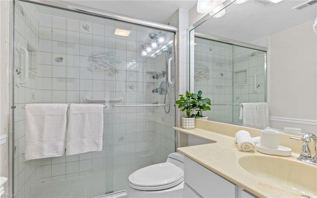 full bathroom with vanity, toilet, and a shower stall